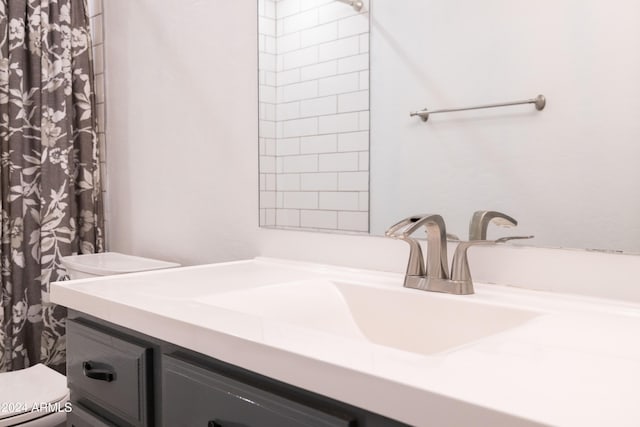 bathroom featuring toilet, a shower with curtain, and vanity