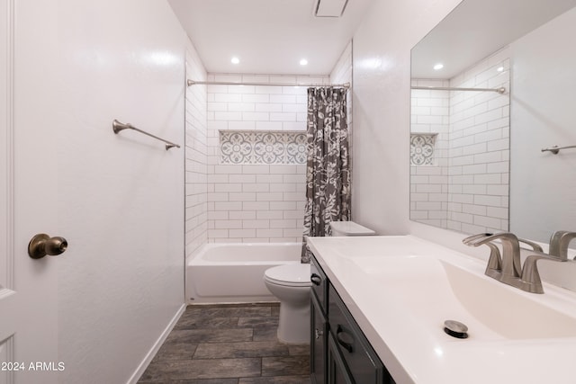 full bathroom with shower / tub combo with curtain, vanity, hardwood / wood-style flooring, and toilet