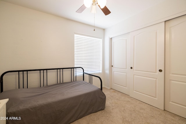 carpeted bedroom with a closet and ceiling fan