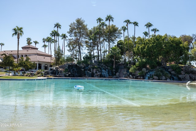 view of pool featuring a water view