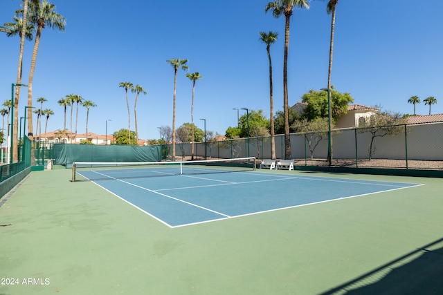 view of tennis court with basketball hoop