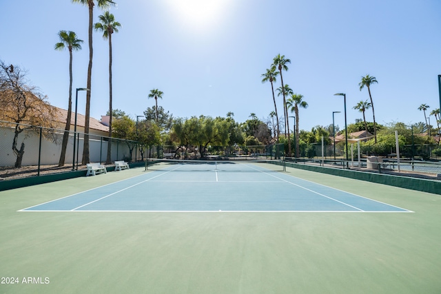 view of tennis court featuring basketball hoop