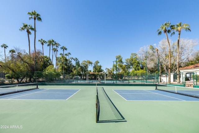 view of tennis court with basketball hoop