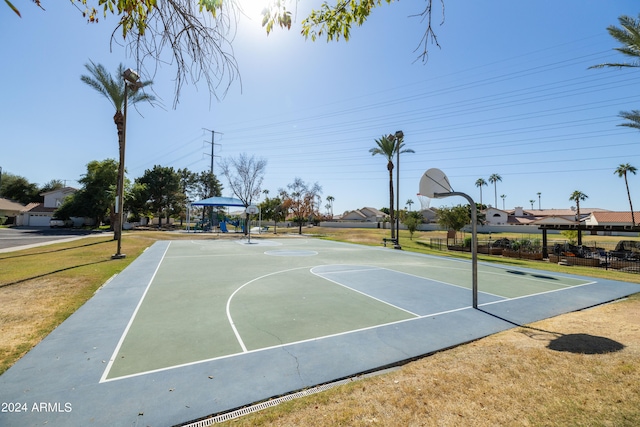 view of sport court featuring a lawn