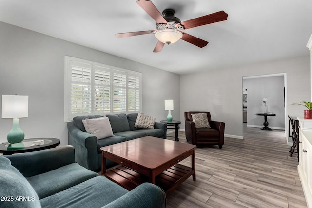 living room featuring ceiling fan and light hardwood / wood-style flooring