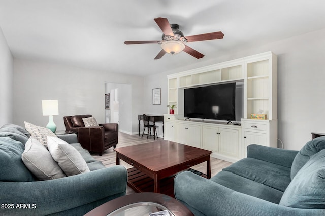 living room featuring light hardwood / wood-style floors and ceiling fan