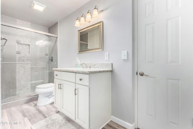 bathroom with vanity, toilet, and walk in shower