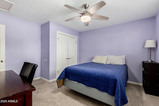 bedroom featuring ceiling fan, light colored carpet, and a closet