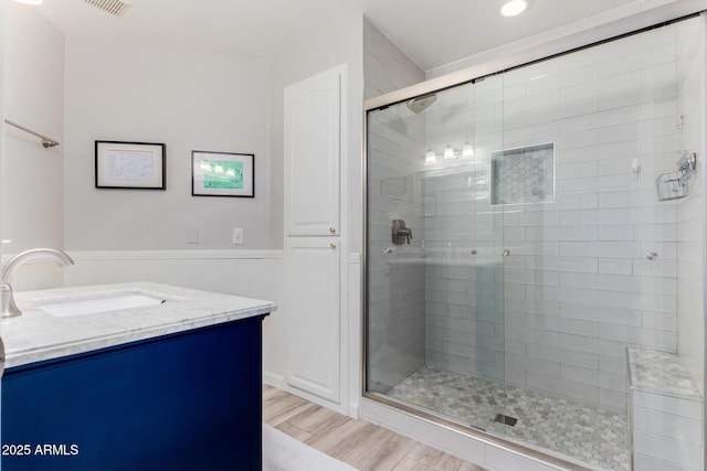 bathroom with vanity, hardwood / wood-style floors, and walk in shower