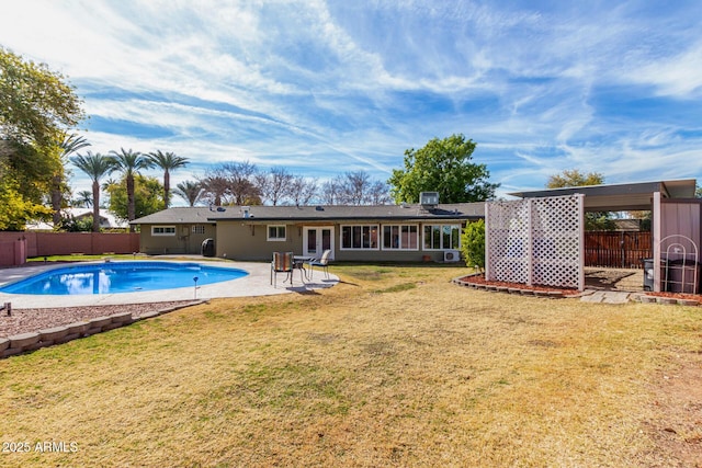 view of pool with a patio area and a lawn