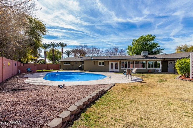 view of pool featuring a lawn, central AC unit, and a patio area