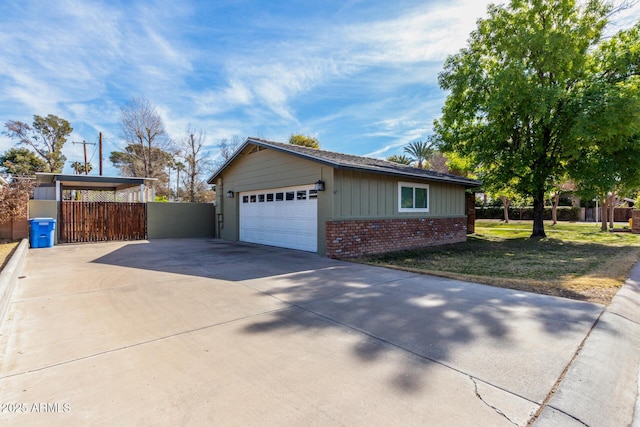 view of side of home with a carport and a lawn