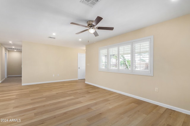 spare room with ceiling fan and light hardwood / wood-style flooring