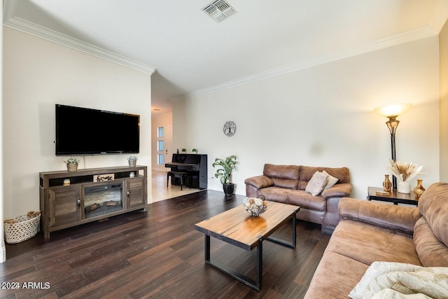 living area with dark wood finished floors, visible vents, and ornamental molding