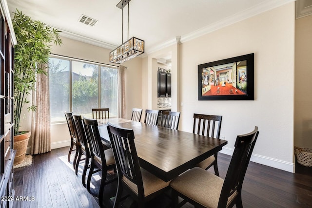 dining room with visible vents, baseboards, crown molding, and dark wood-type flooring