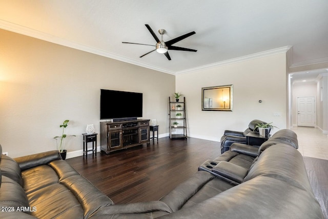 living room featuring ornamental molding, a ceiling fan, baseboards, and wood finished floors