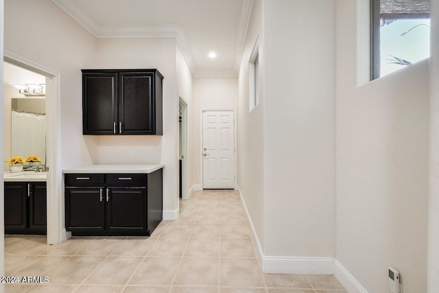 corridor with light tile patterned floors, baseboards, ornamental molding, and recessed lighting