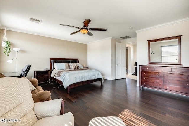 bedroom featuring dark wood-type flooring, visible vents, and ornamental molding