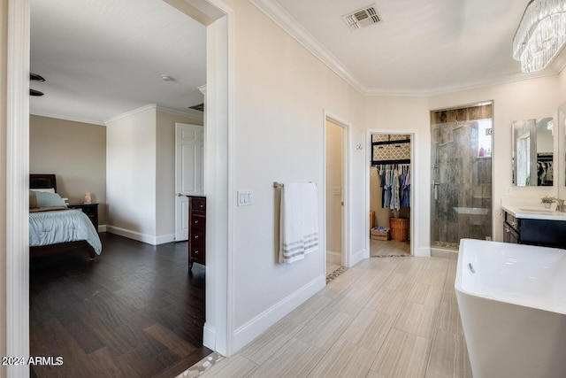 full bathroom with a spacious closet, visible vents, crown molding, baseboards, and a stall shower