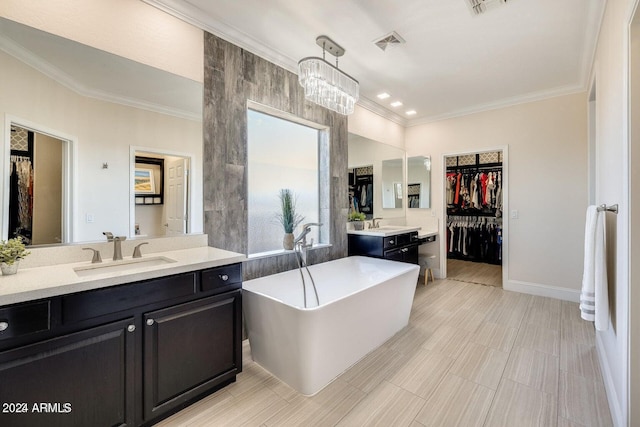 bathroom featuring a walk in closet, crown molding, a freestanding tub, and a sink