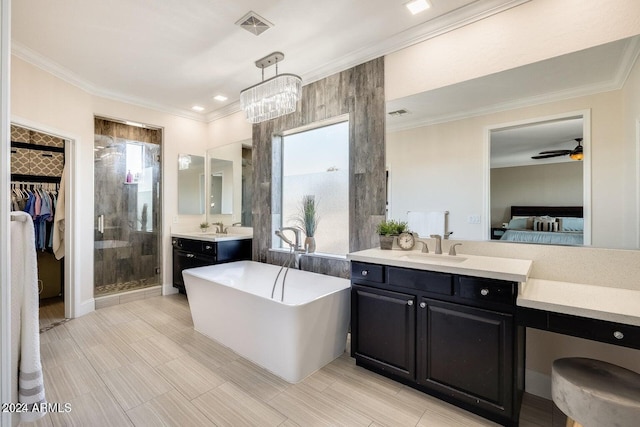 ensuite bathroom with visible vents, a stall shower, crown molding, a freestanding bath, and vanity