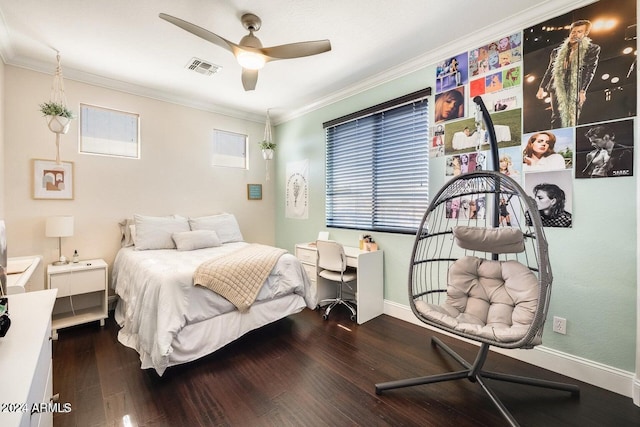 bedroom featuring visible vents, wood finished floors, crown molding, baseboards, and ceiling fan