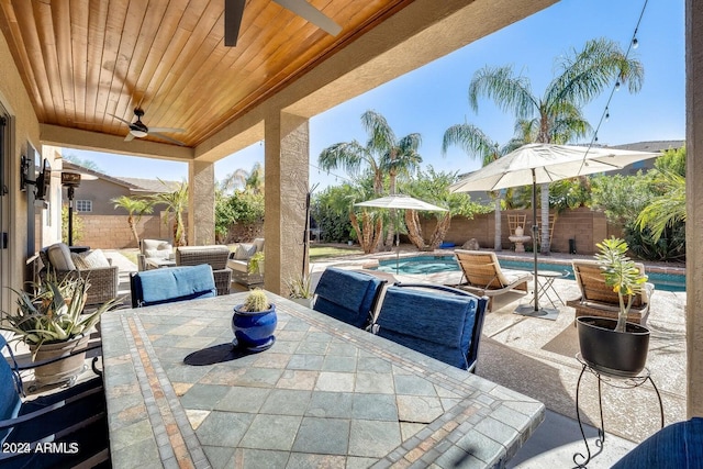 view of patio / terrace with an outdoor living space, a fenced in pool, ceiling fan, a fenced backyard, and outdoor dining space