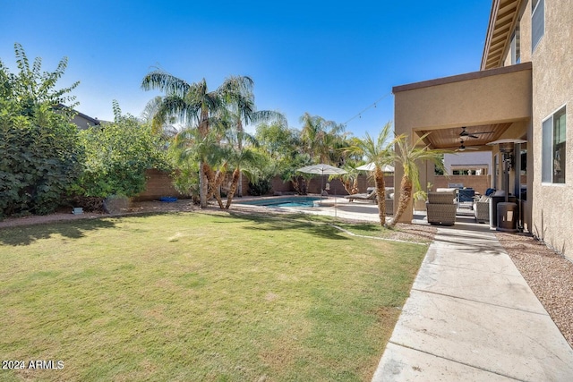 view of yard featuring a fenced in pool, a patio, outdoor lounge area, and a fenced backyard