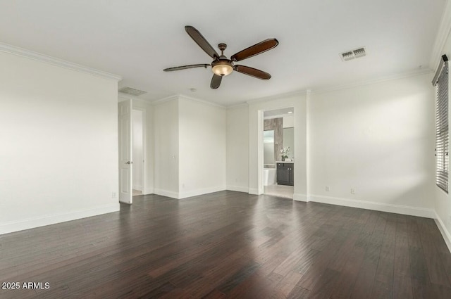 spare room featuring dark wood finished floors, baseboards, visible vents, and ornamental molding