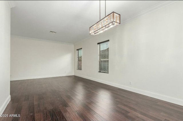 unfurnished room featuring dark wood-style floors, crown molding, and baseboards