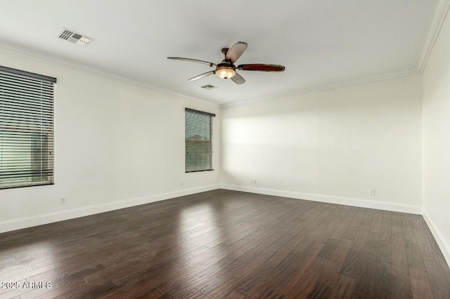 spare room with ceiling fan, visible vents, dark wood-style flooring, and ornamental molding