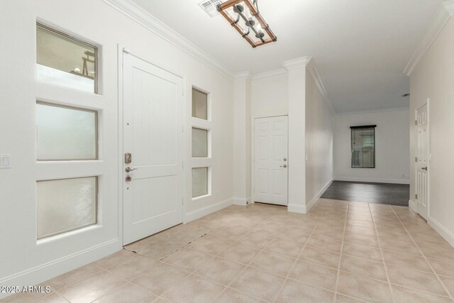 entrance foyer featuring light tile patterned floors, visible vents, baseboards, and crown molding