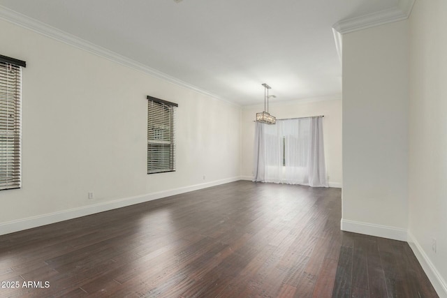 spare room with baseboards, dark wood-style flooring, and ornamental molding