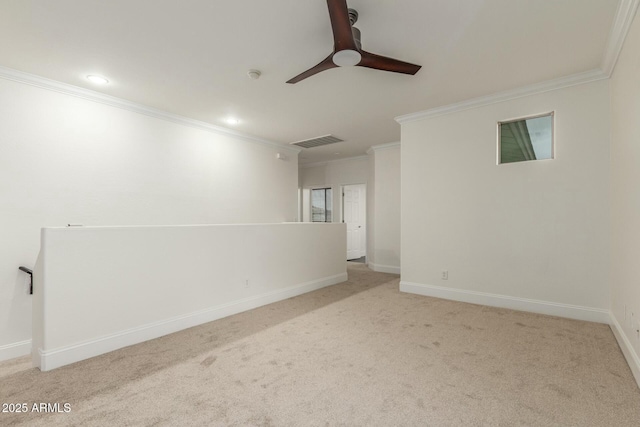 unfurnished room featuring carpet, baseboards, visible vents, ornamental molding, and ceiling fan