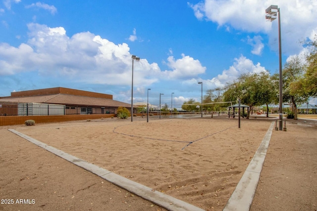 view of community with volleyball court and fence