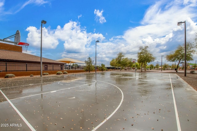 view of basketball court featuring community basketball court and fence