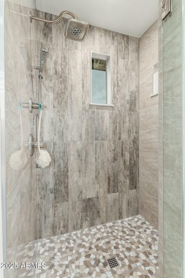 bathroom with a tile shower