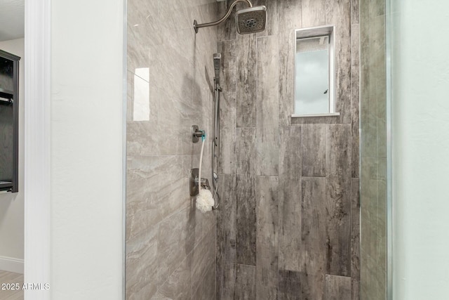 full bath with a tile shower