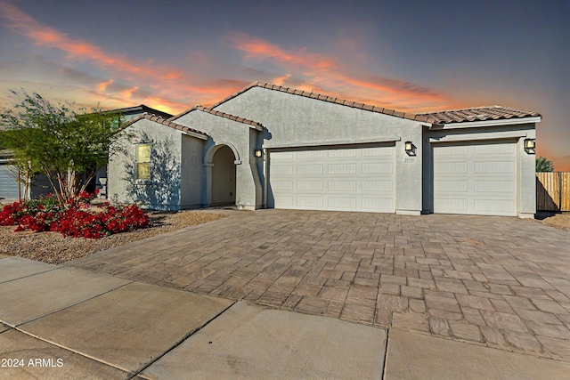 mediterranean / spanish home featuring a garage