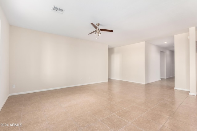 tiled empty room with ceiling fan