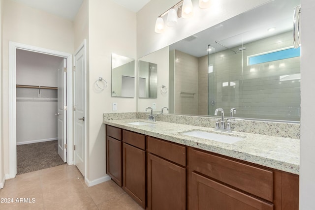 bathroom featuring tile patterned flooring, vanity, and a shower with door