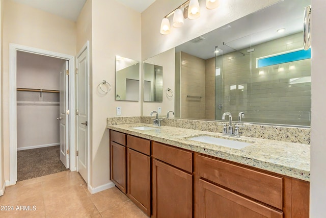 bathroom with tile patterned floors, vanity, and a shower with door