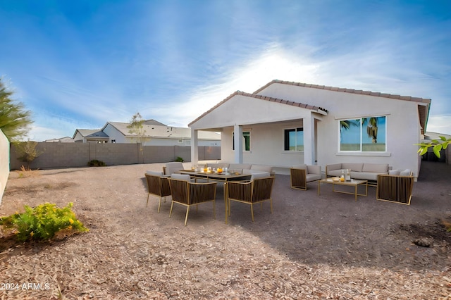 back of property with an outdoor living space