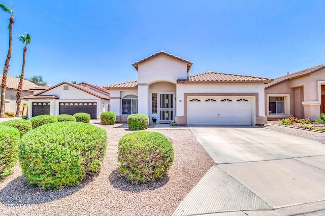 925 W San Marcos Dr, Chandler, AZ 85225 - mediterranean / spanish house featuring an attached garage, stucco siding, driveway, and a tile roof