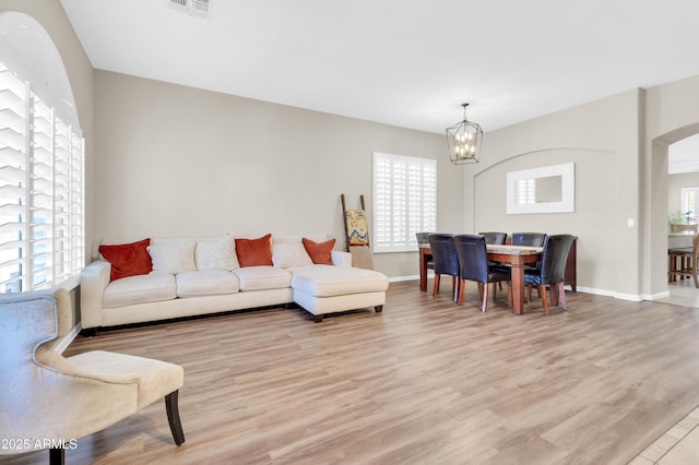 925 W San Marcos Dr, Chandler, AZ 85225 - living room featuring a chandelier, light wood-style flooring, and arched walkways