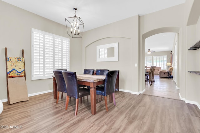 925 W San Marcos Dr, Chandler, AZ 85225 - dining room featuring arched walkways, a chandelier, and light wood finished floors