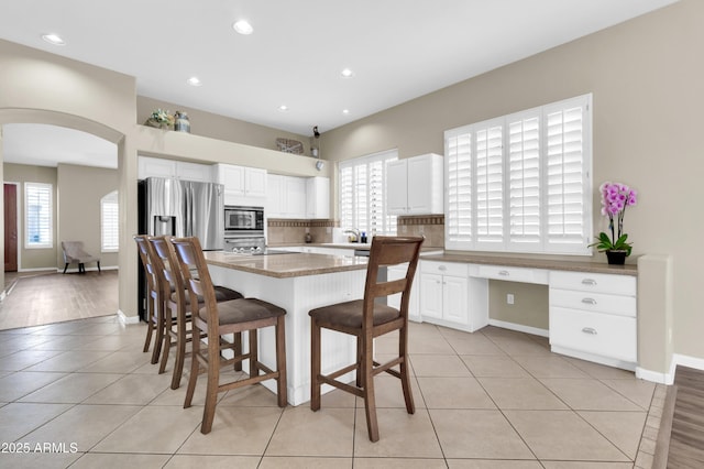 925 W San Marcos Dr, Chandler, AZ 85225 - dining area with healthy amount of natural light, arched walkways, light tile patterned floors, recessed lighting, and built in study area