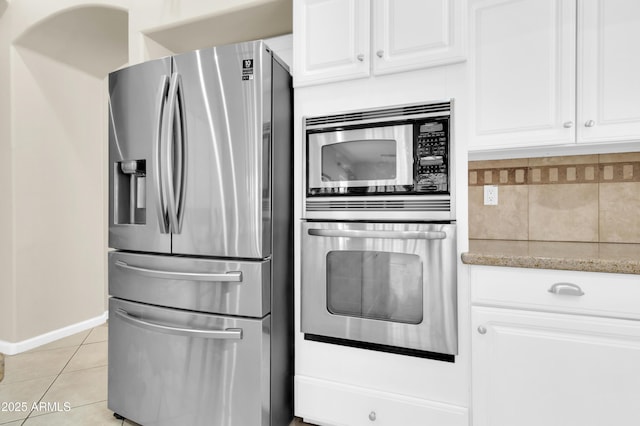 925 W San Marcos Dr, Chandler, AZ 85225 - kitchen featuring appliances with stainless steel finishes, light stone counters, white cabinets, tasteful backsplash, and light tile patterned floors
