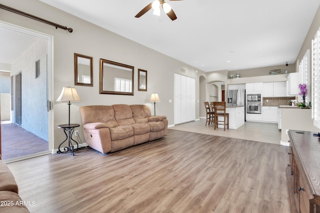925 W San Marcos Dr, Chandler, AZ 85225 - living area featuring ceiling fan, light wood finished floors, and arched walkways