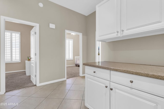 925 W San Marcos Dr, Chandler, AZ 85225 - kitchen with light carpet, white cabinets, and light tile patterned flooring